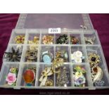 A quantity of costume brooches inc. porcelain brooches.