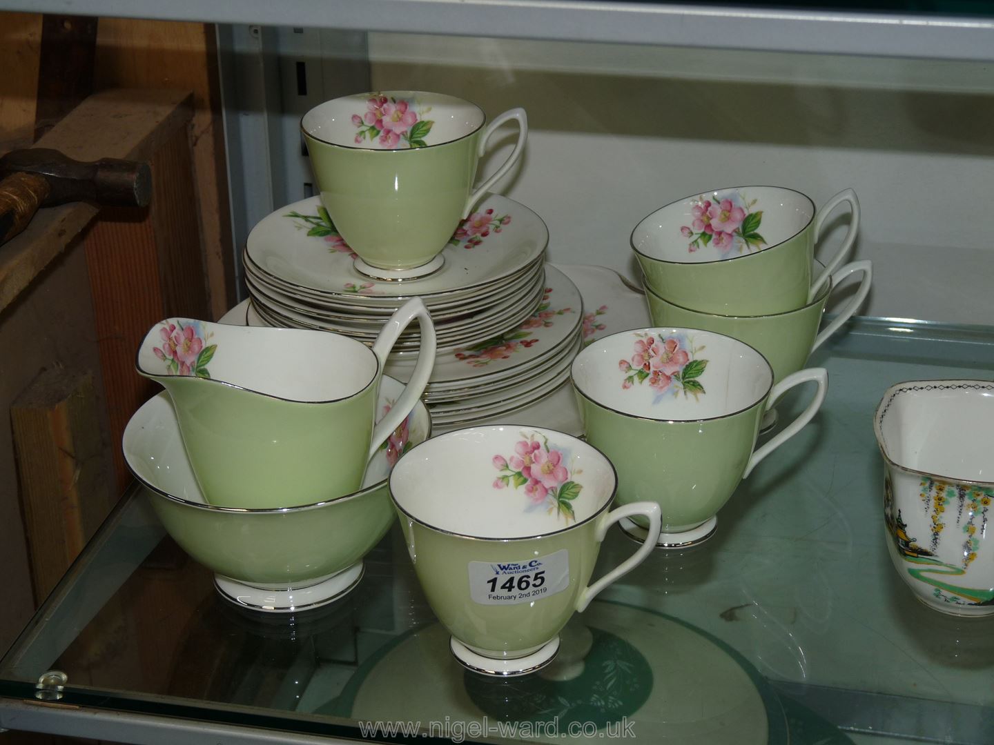 A Royal Albert part Teaset in pale green with pink roses; five cups, six saucers, six plates,