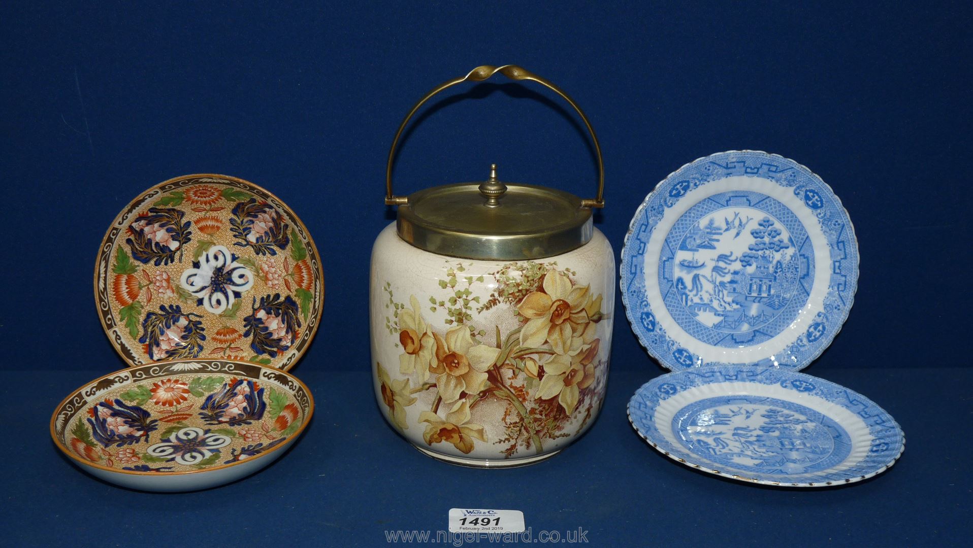 A Victorian biscuit barrel decorated with daffodils along with an EPNS lid;