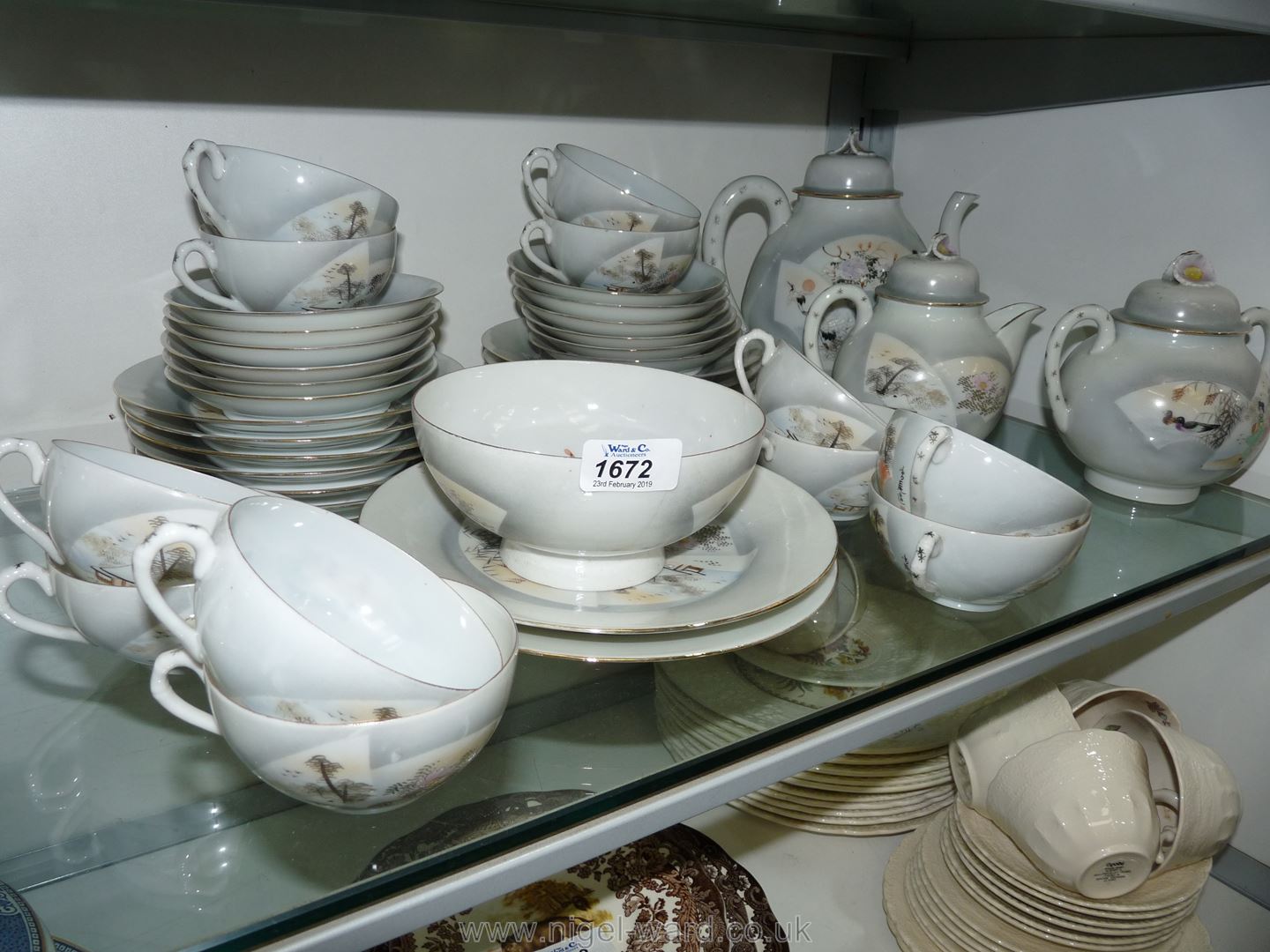 An oriental Teaset having teapot, sugar bowl, two handled lidded sucrier, tea cups,