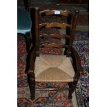 An appealing seagrass seated child's ladder back Elbow Chair