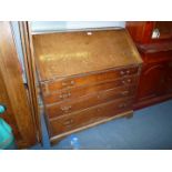 An Oak Bureau, the slope front revealing an interior with drawers,