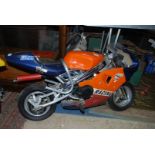 A Repsol mini-moto motorbike in working order.