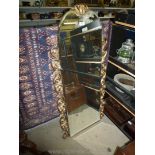 An arched bevelled wall Mirror having gilded scroll side details,