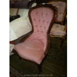 A reproduction Mahogany framed button back Lady's Chair on cabriole front legs and upholstered in