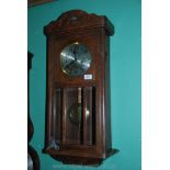 A 1920/30's Oak cased wall Clock having silvered metal dial with Arabic numerals,