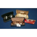 Four pairs of cased spectacles
