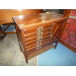 A circa 1930 Mahogany music Cabinet having six fall front, sheet music drawer,