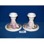 A pair of Moorcroft candlesticks,