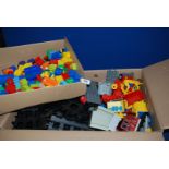 A large box of Lego train track and train, and a small box of Lego Duplo.