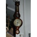 A Walnut cased five point Banjo Barometer featuring a hygrometer, thermometer, mirror,