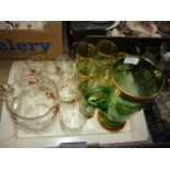 A lemonade set with a jug and six glasses decorated with poppies and a green and gold lemonade set