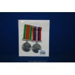 Two WWII Defence and war medals, mounted on boards.