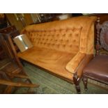 An Edwardian Mahogany framed four seater Sofa/Settle upholstered in gold/brown draylon fabric,