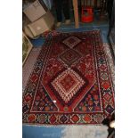 A red patterned wool Rug.