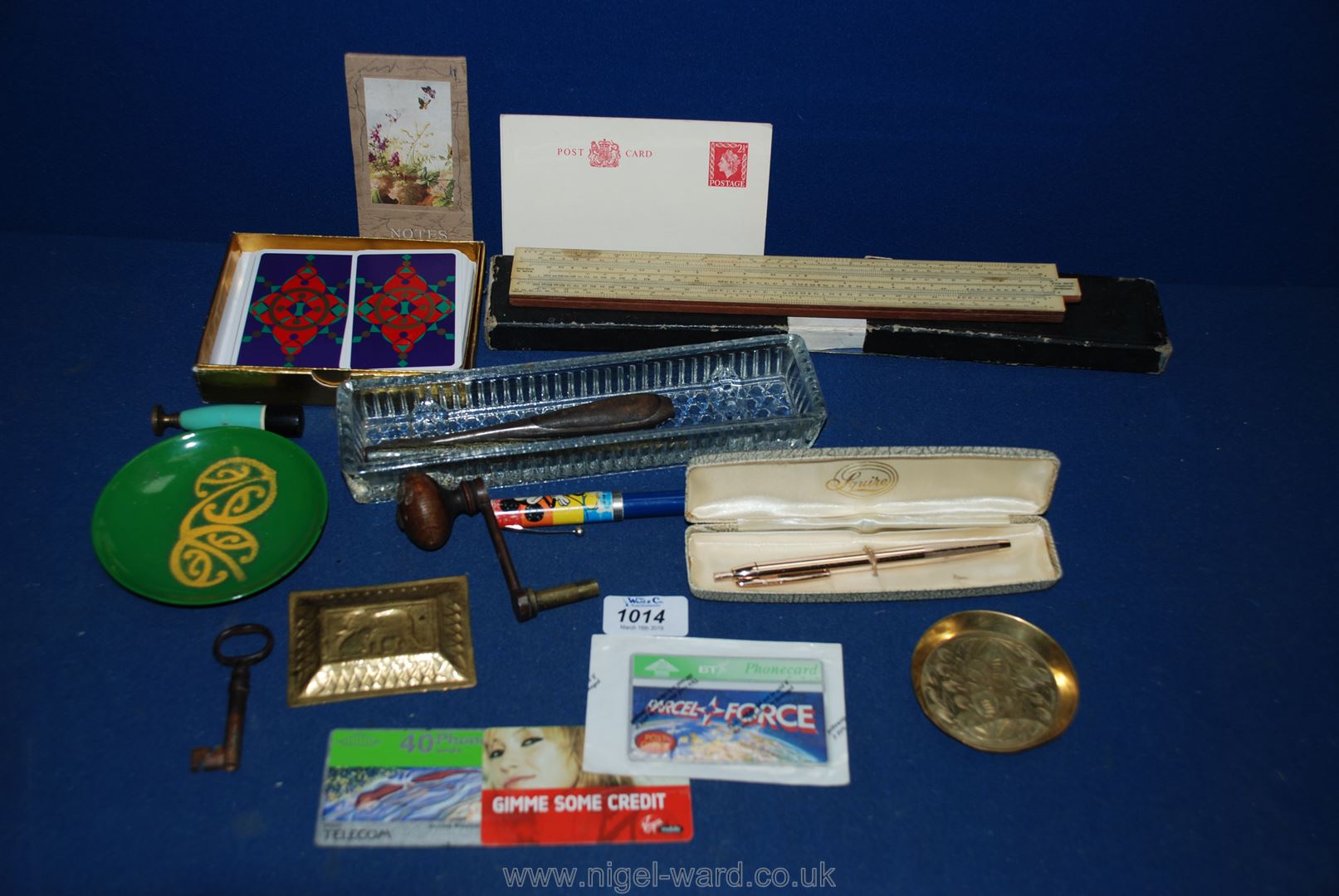 A box including clock winder, pen tray, slide rule, etc.