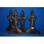 Four antique oak pew ends, carved with poppy head finials.