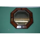 An octagonal wooden framed bevel plated Wall Mirror