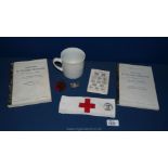 A quantity of German militaria including 3rd Reich Coffee Mug, red cross armband, two cap Badges,