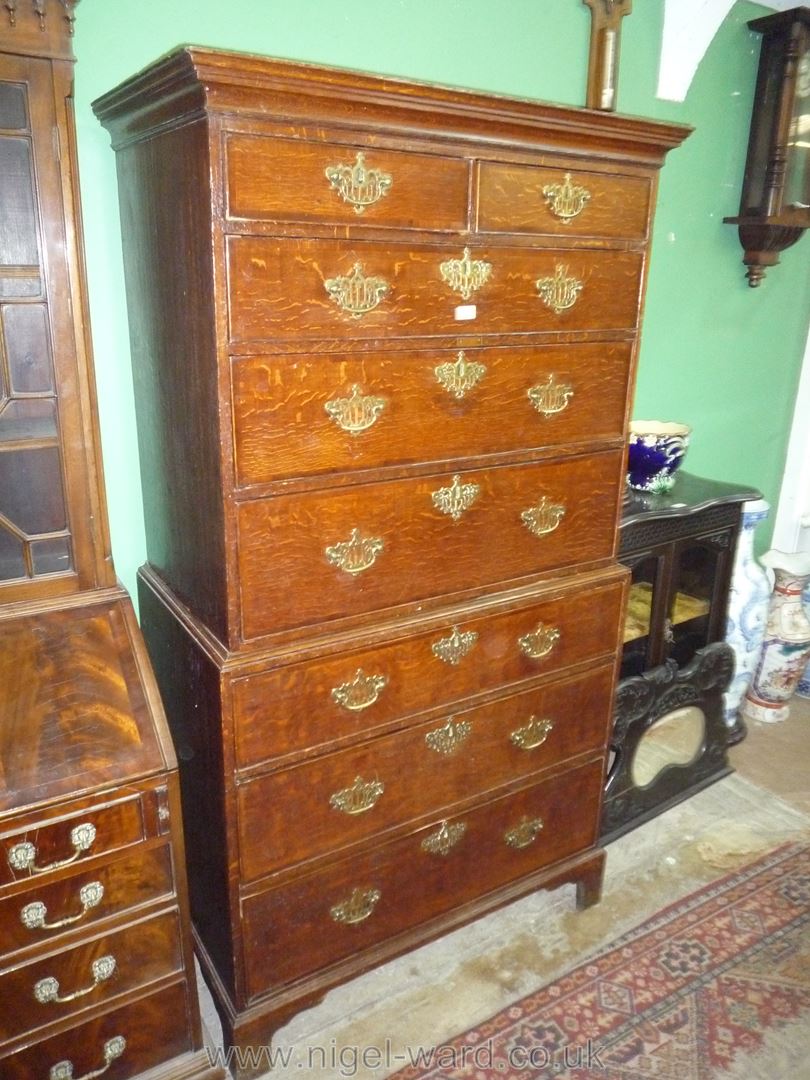 An Oak Chest on Chest having cross-banded drawer fronts,