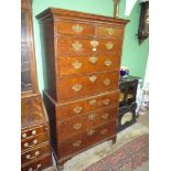 An Oak Chest on Chest having cross-banded drawer fronts,