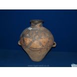 A Chinese Neolithic double handled Jar decorated in black with zigzags and stylised leaves,