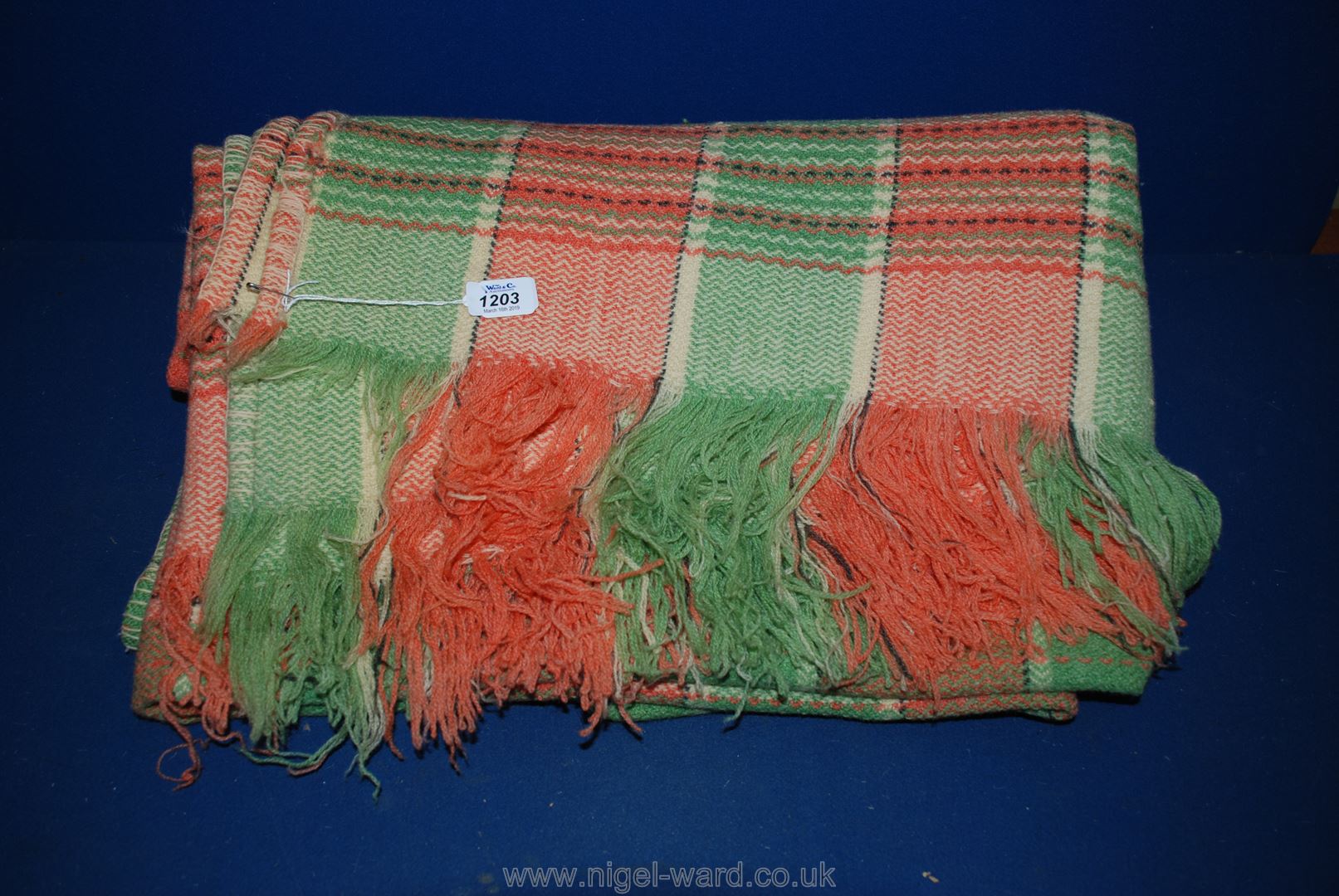 A Welsh Blanket in green and orange check