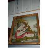 A Victorian Woolwork embroidery picture of a young girl reading under a tree,