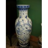 A large blue and white oriental floor Vase, decorated with embossed dragons,