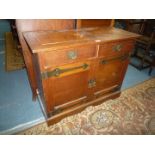 An Oak arts and crafts double doored,