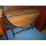 An Oak dropleaf gateleg Table, on turned shaped legs,