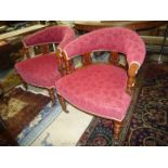 A pair of darkwood framed Edwardian curved back low Armchairs,