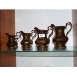 Four graduated Wade gold lustre Jugs.