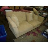 A modern 3/4 seater Settee upholstered in beige chequer patterned fabric and standing on brief legs,