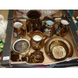 A quantity of copper lustre items including three jugs, plaque, salt and pepper, etc.