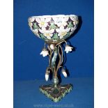 A ceramic and metal table centre piece with profuse daisy flower decoration on twisted stem metal