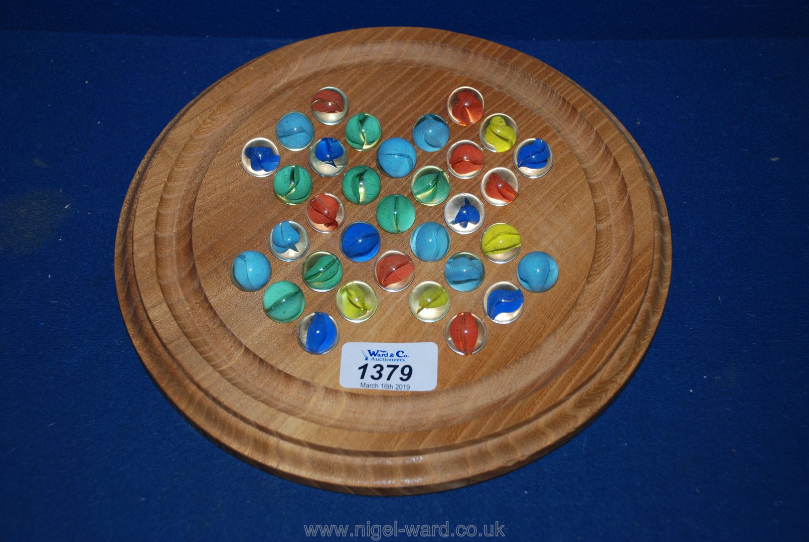 A jar of Marbles and a Solitaire board with marbles