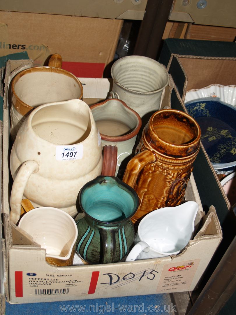 A quantity of jugs and vases including Quart tankard, Arthur Woods, Scorrier, Cornwall, Tregarron,