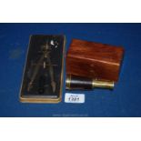 A miniature telescope, marked Rose London in a wooden box along with a compass.