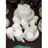 A quantity of dinner/tea ware in white with gold trim, dinner plates, side plates, saucers, cups,