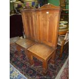 A pair of Oak Hall Chairs of ecclesiastic flavour standing on heavy fluted square legs,