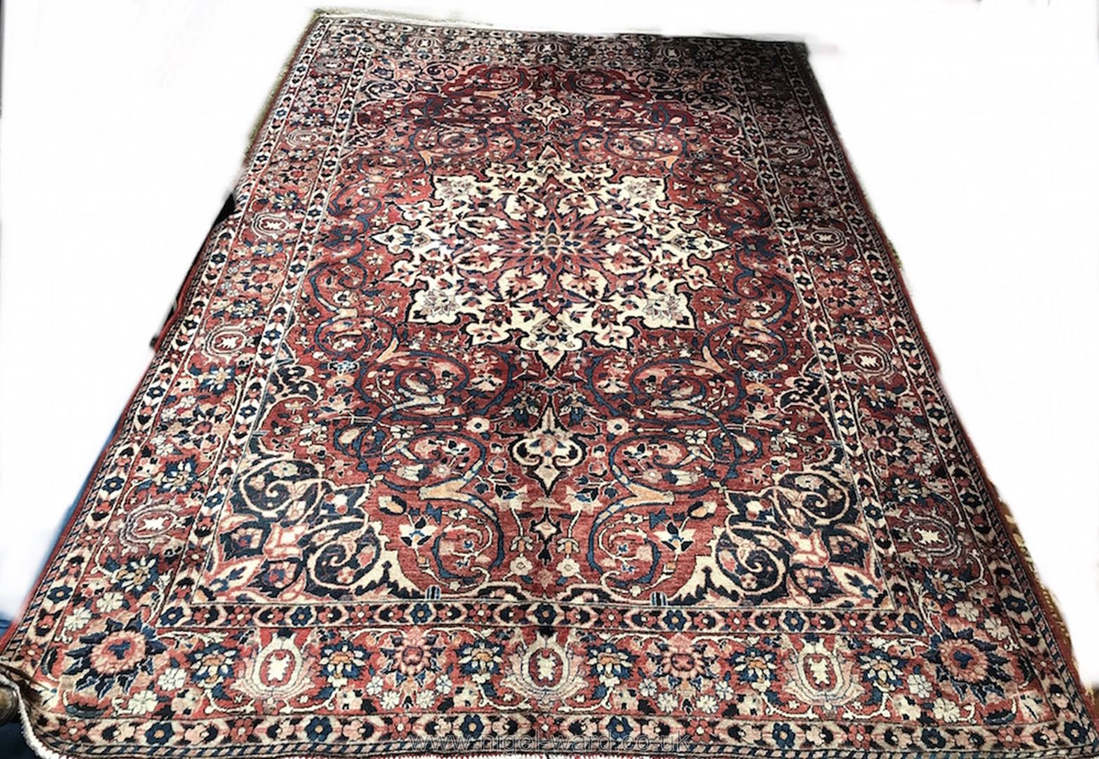 A large hand-made Kerman Carpet,