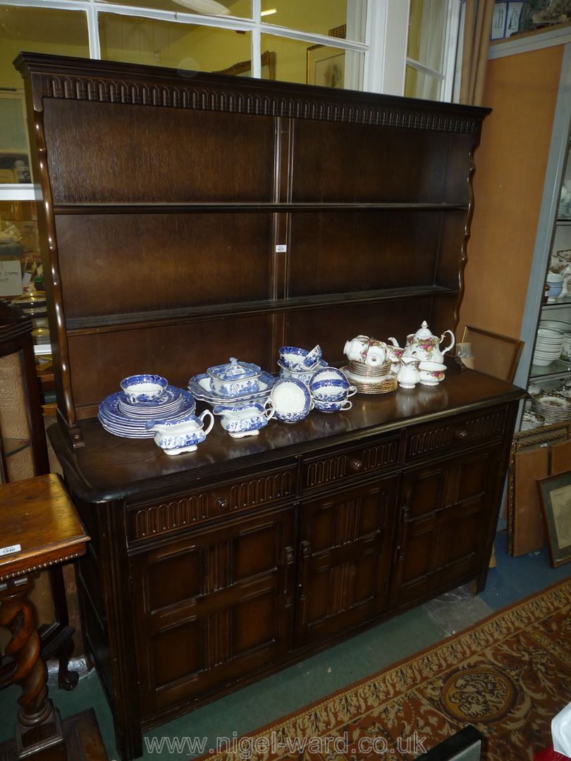 A dark Oak contemporary Dresser, the base with three cupboards and three frieze drawers,