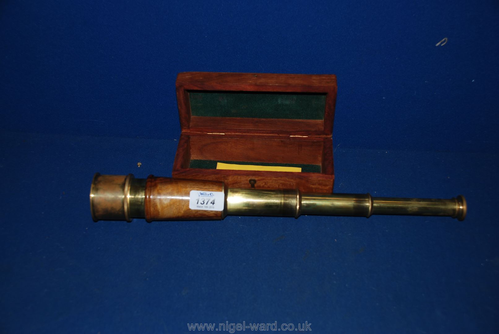 An extending pocket telescope and wooden case.