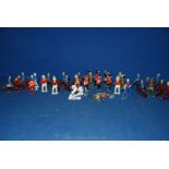 A quantity of painted vintage lead soldiers and vintage lead cowboys & Indians.