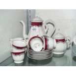 A Coffee set marked FP, white ground with burgundy and gold decoration.