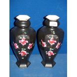 A pair of black ground Vases, with hand-painted rose decoration,