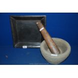 A wooden Pestle and stone mortar,