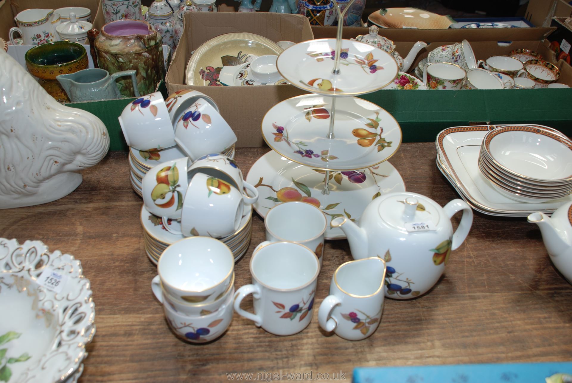 A Royal Worcester Evesham teaset comprising teapot, sugar basins, milk jugs, tea plates, cups,