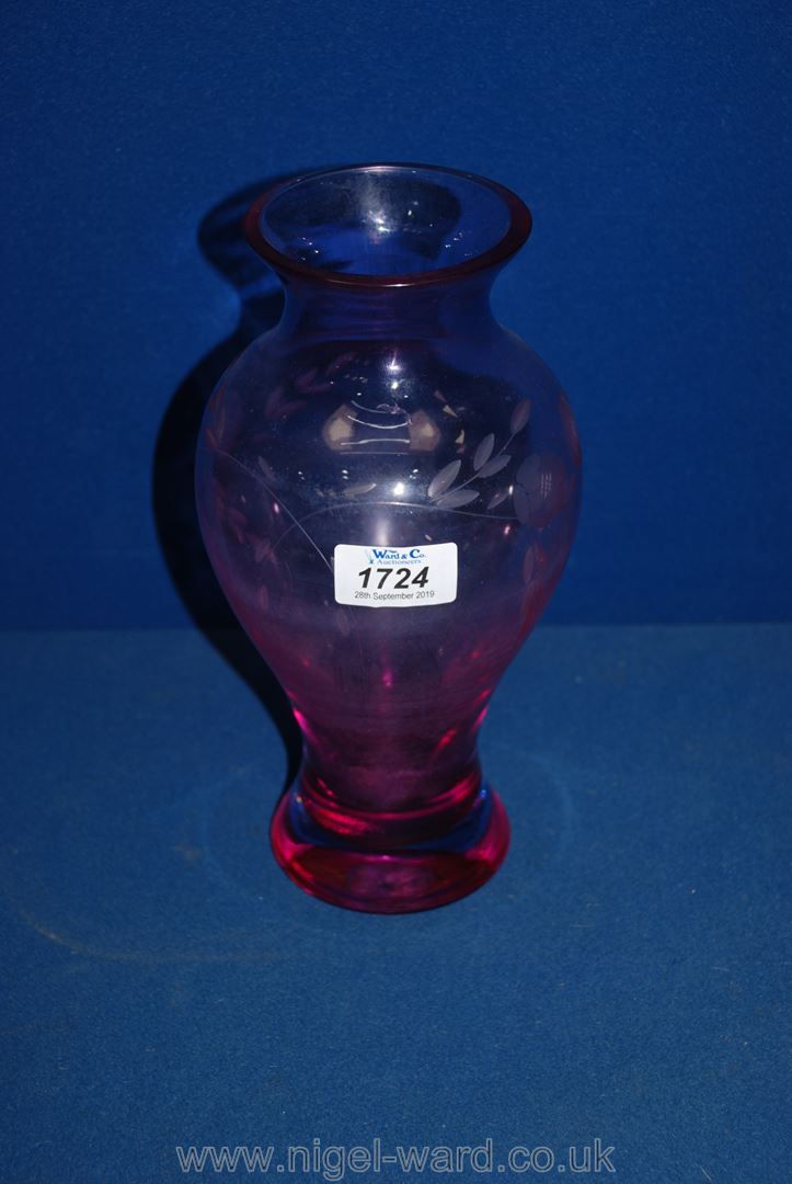 A Caithness Vase in mauve glass with etched floral decoration, 9 3/4" tall.